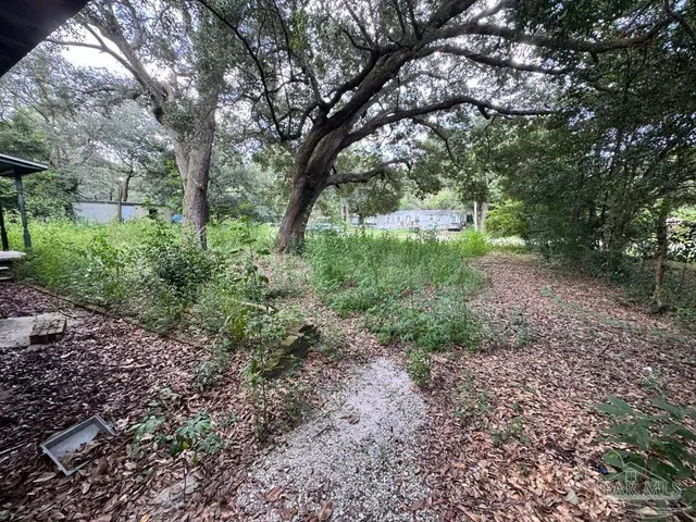 a backyard of a house with lots of green space and lake view