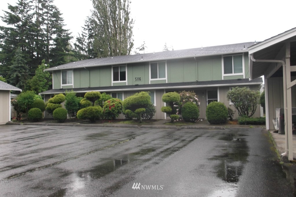 5116 Parker Road East Sumner, WA 98390 - Photo 1 of 8 a front view of a house with garden
