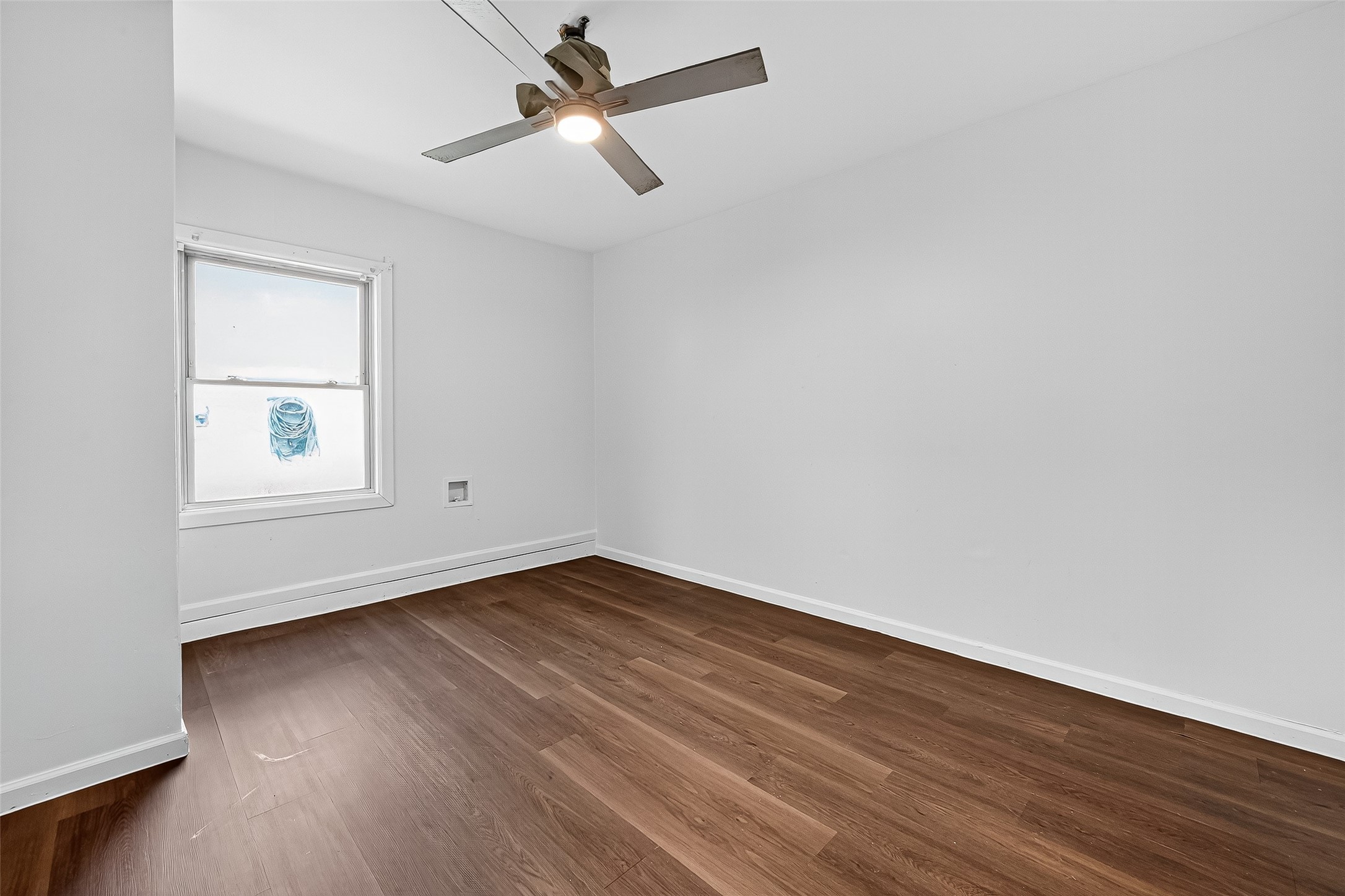 22819 Cabanna Road Spring, TX 77389 - Photo 11 of 26 an empty room with wooden floor fan and windows