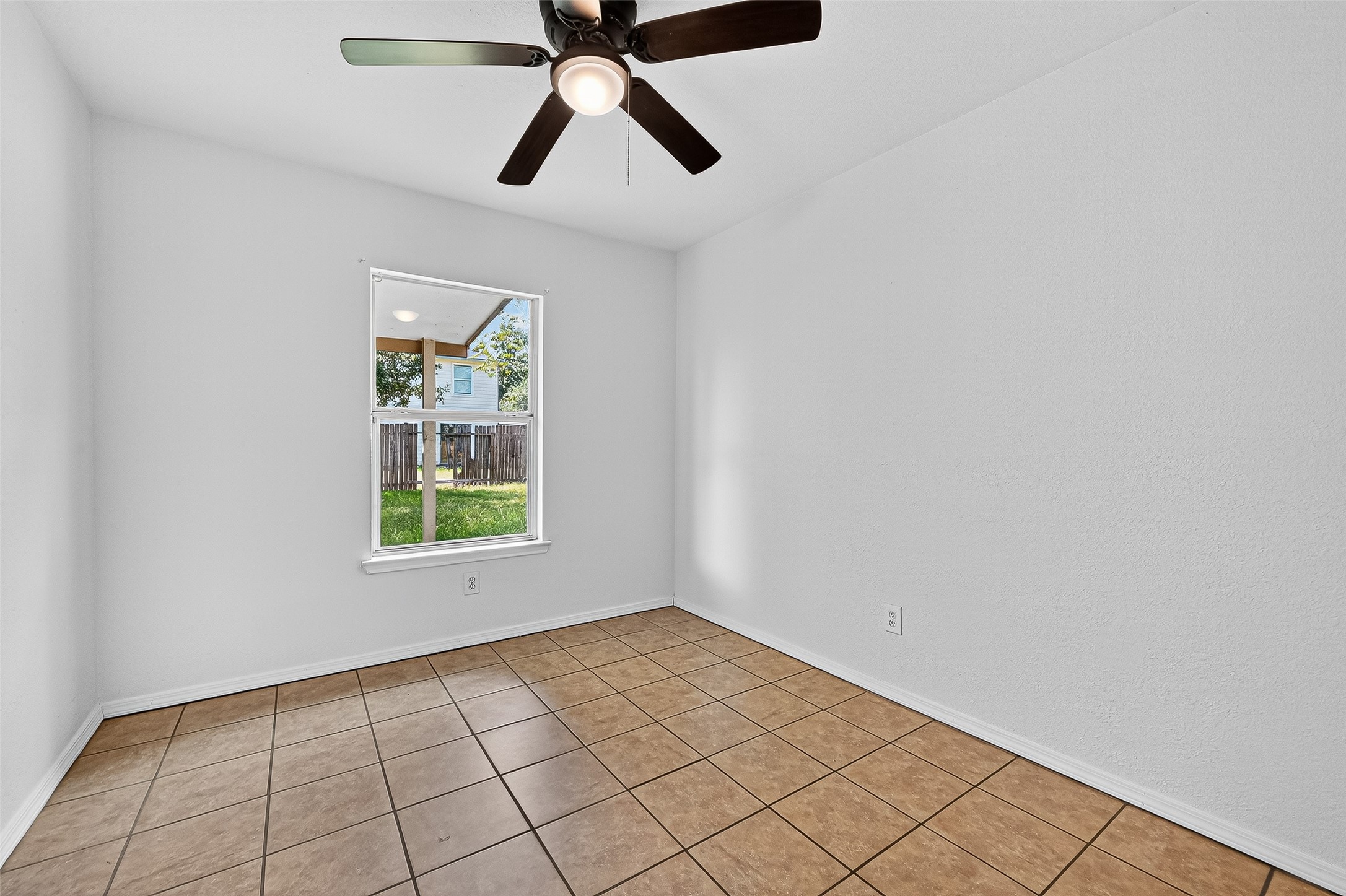22819 Cabanna Road Spring, TX 77389 - Photo 14 of 26 an empty room with windows and fan