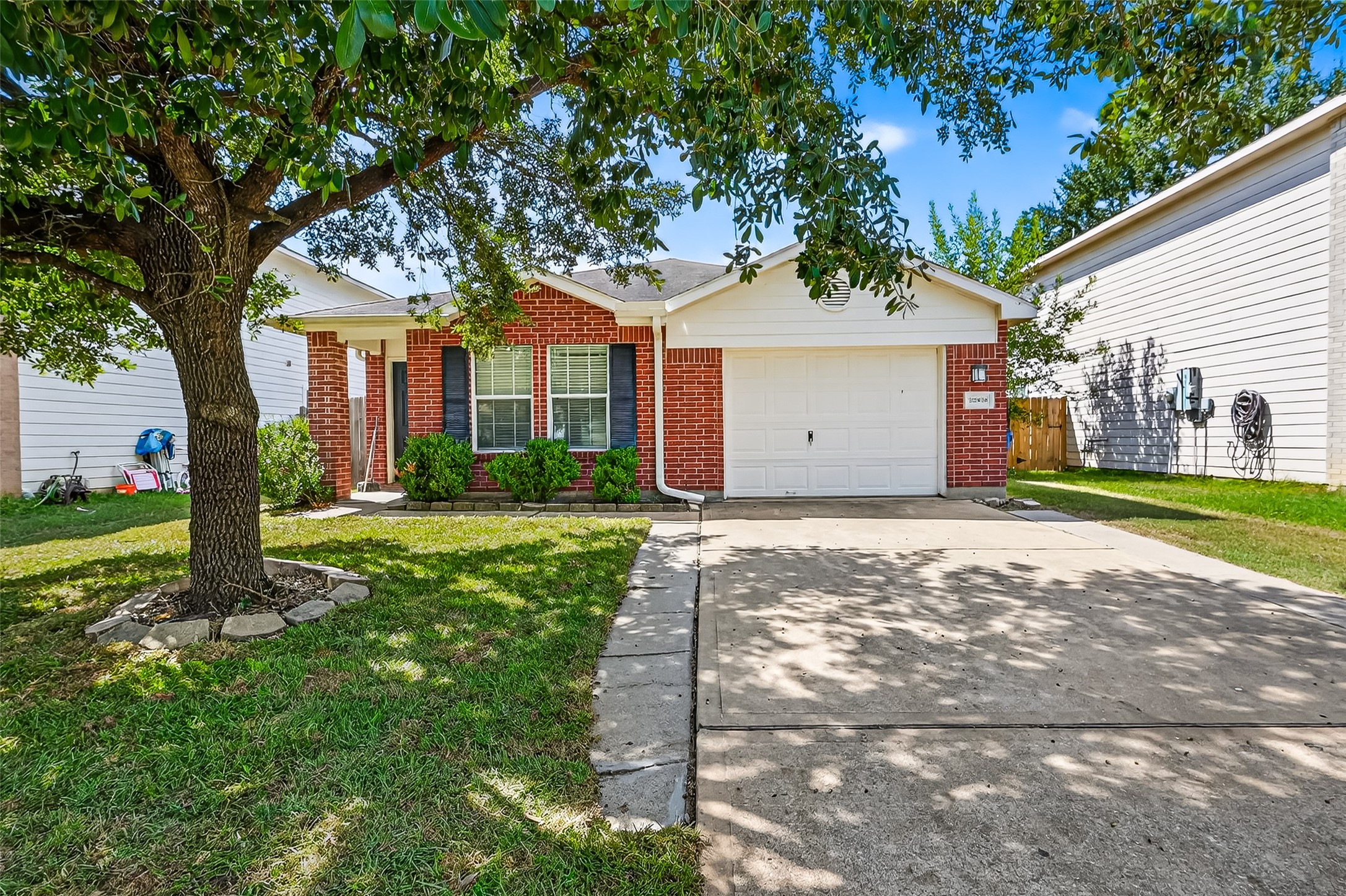22819 Cabanna Road Spring, TX 77389 - Photo 3 of 26 a front view of a house with a yard and garage