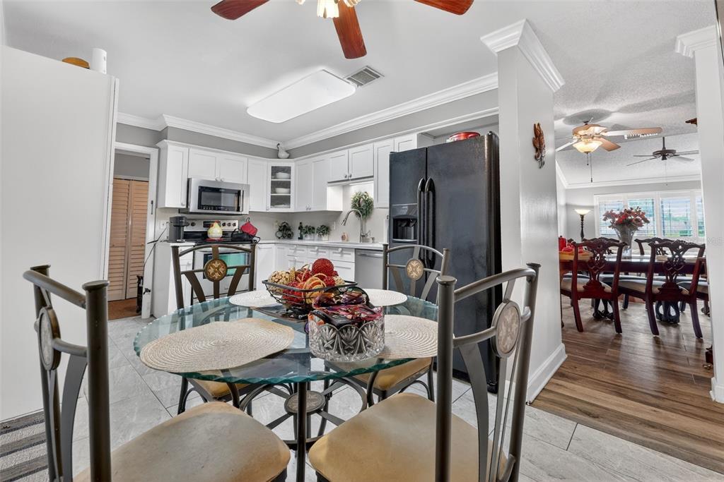 575 Tiberon Cove Road Longwood, FL 32750 - Photo 20 of 56 a view of a dining room with furniture and a kitchen