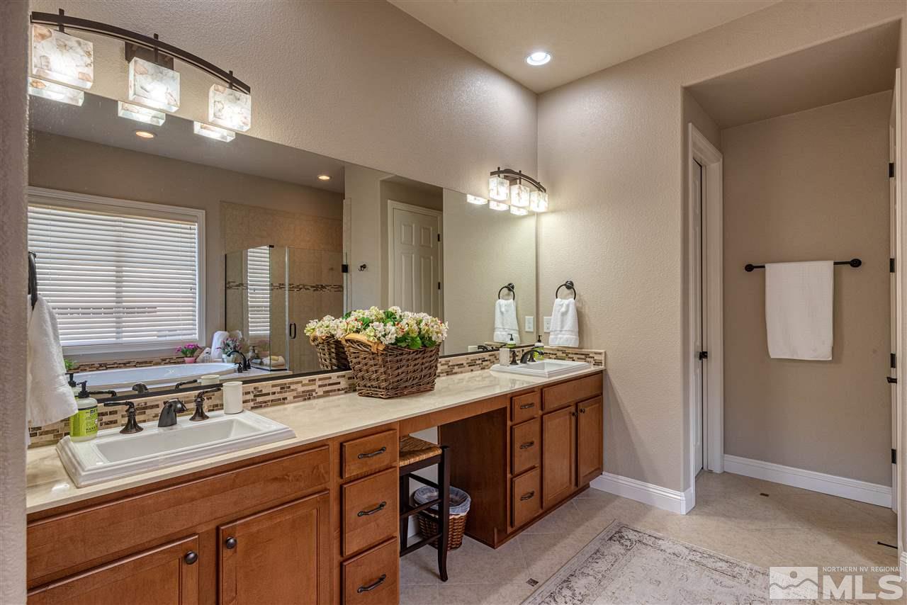 2060 Blue Boy Lane Reno, NV 89521 - Photo 16 of 25 a bathroom with a double vanity sink and a mirror
