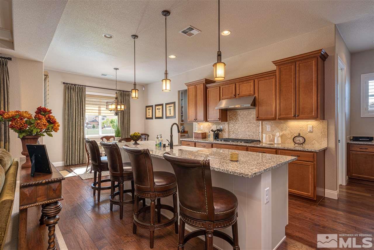 2060 Blue Boy Lane Reno, NV 89521 - Photo 7 of 25 a kitchen with a dining table chairs sink and cabinets