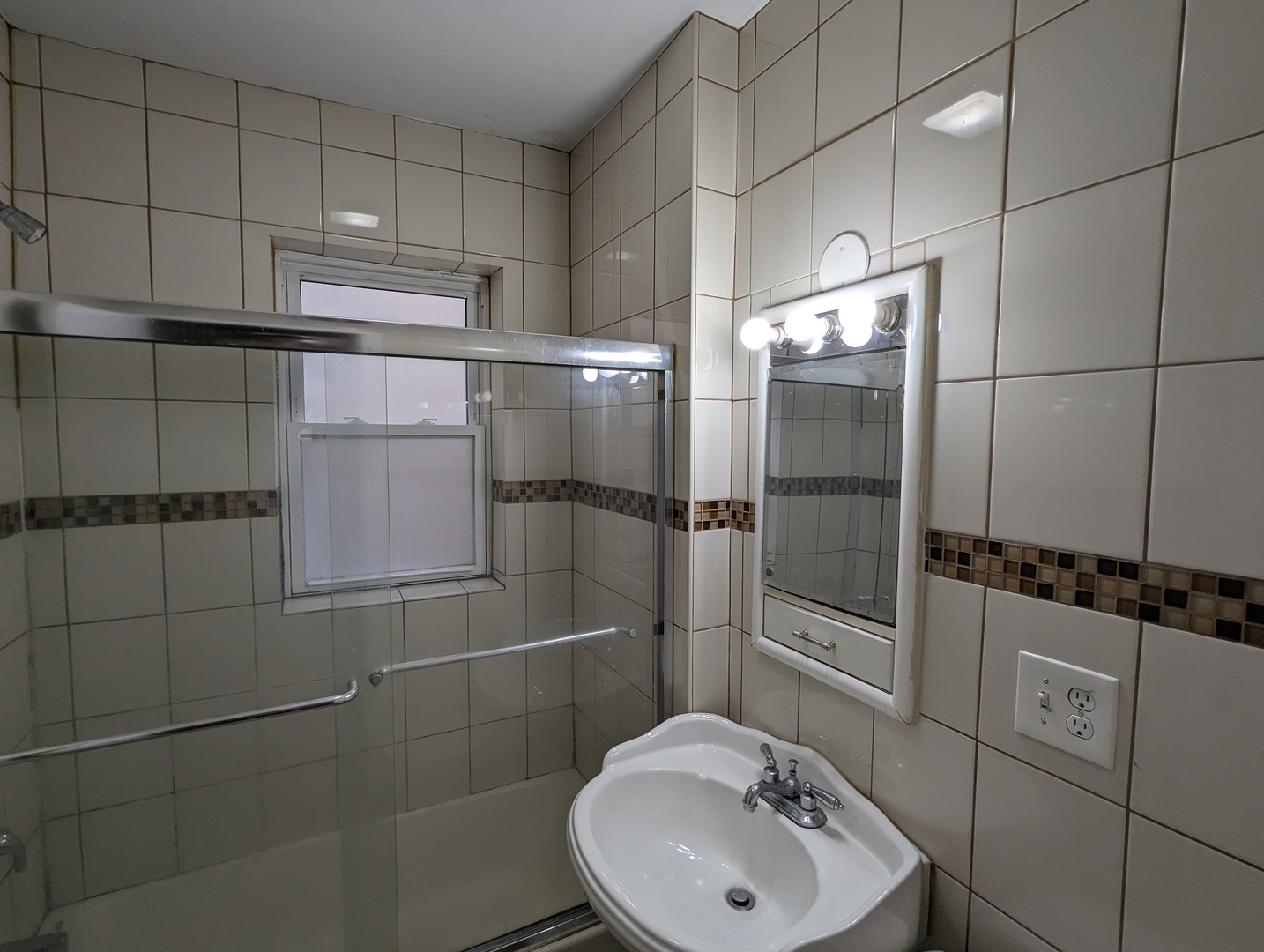 5029 North Harding Avenue, Unit 1W Chicago, IL 60625 - Photo 14 of 18 a bathroom with a sink toilet and shower