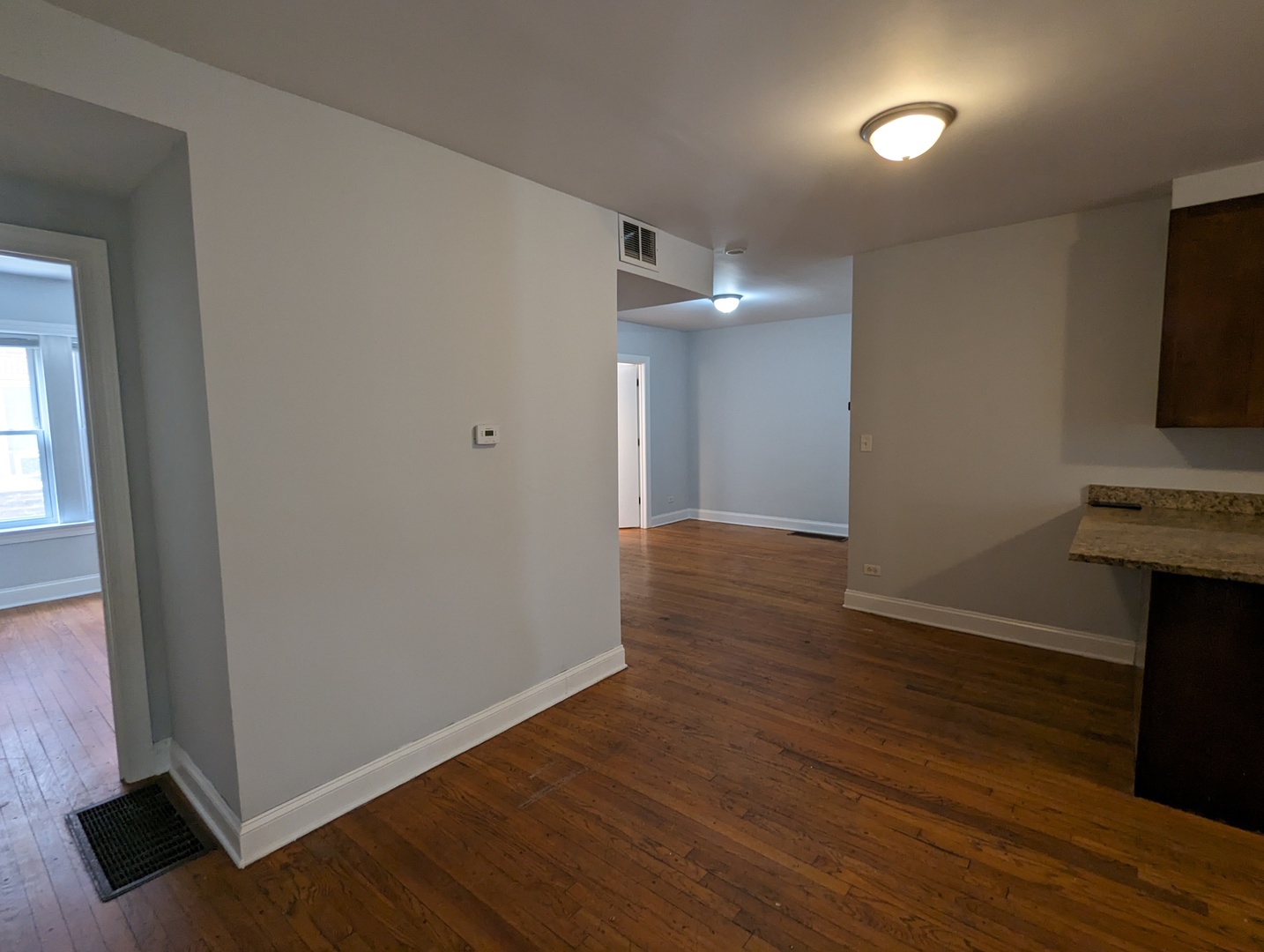 5029 North Harding Avenue, Unit 1W Chicago, IL 60625 - Photo 16 of 18 wooden floor in an empty room with a window