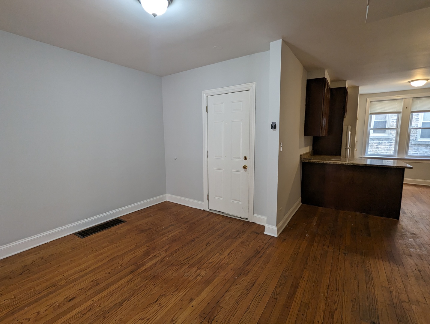 5029 North Harding Avenue, Unit 1W Chicago, IL 60625 - Photo 3 of 18 wooden floor in an empty room with a window