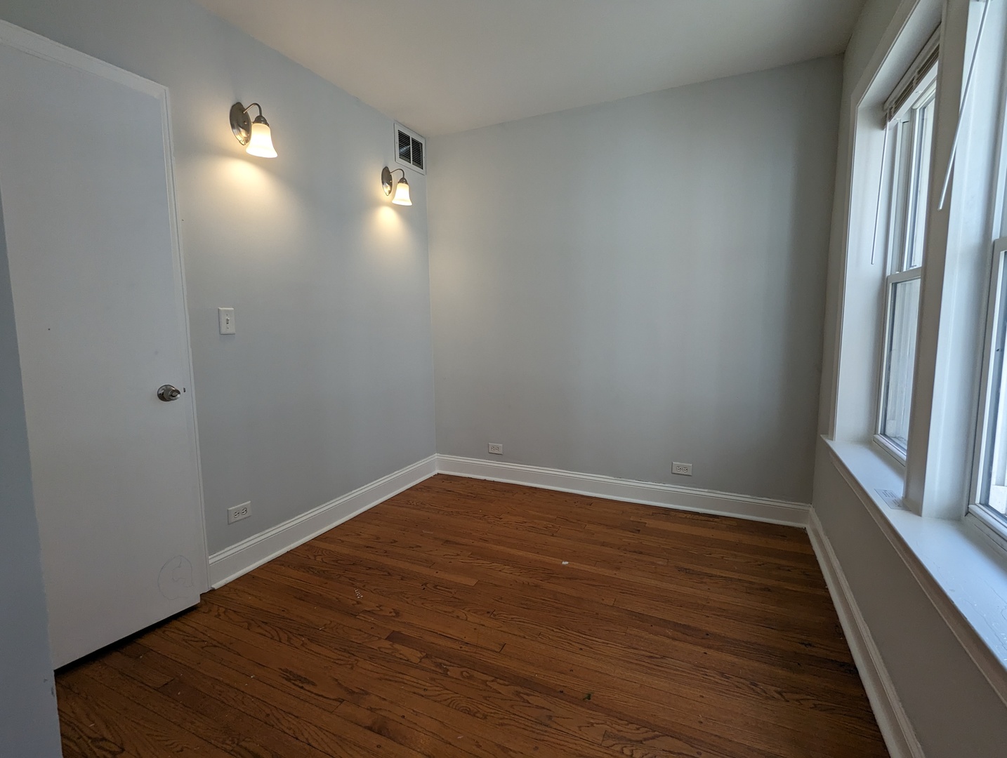 5029 North Harding Avenue, Unit 1W Chicago, IL 60625 - Photo 5 of 18 a view of empty room with wooden floor and fan