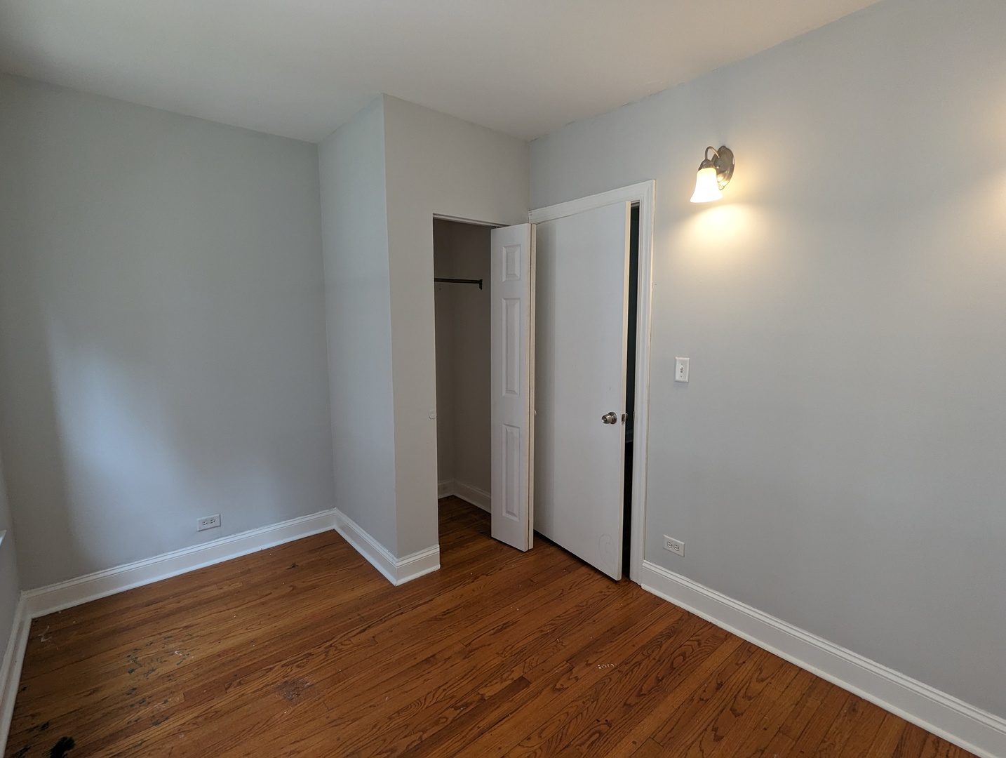 5029 North Harding Avenue, Unit 1W Chicago, IL 60625 - Photo 7 of 18 wooden floor in an empty room