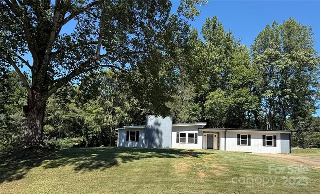 a view of a white house with a large pool
