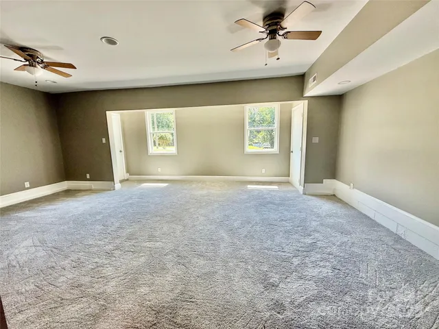a en suite bathroom with a granite countertop sink and a mirror