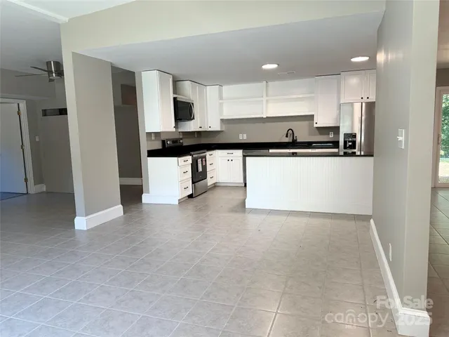 a view of kitchen with refrigerator sink and a stove