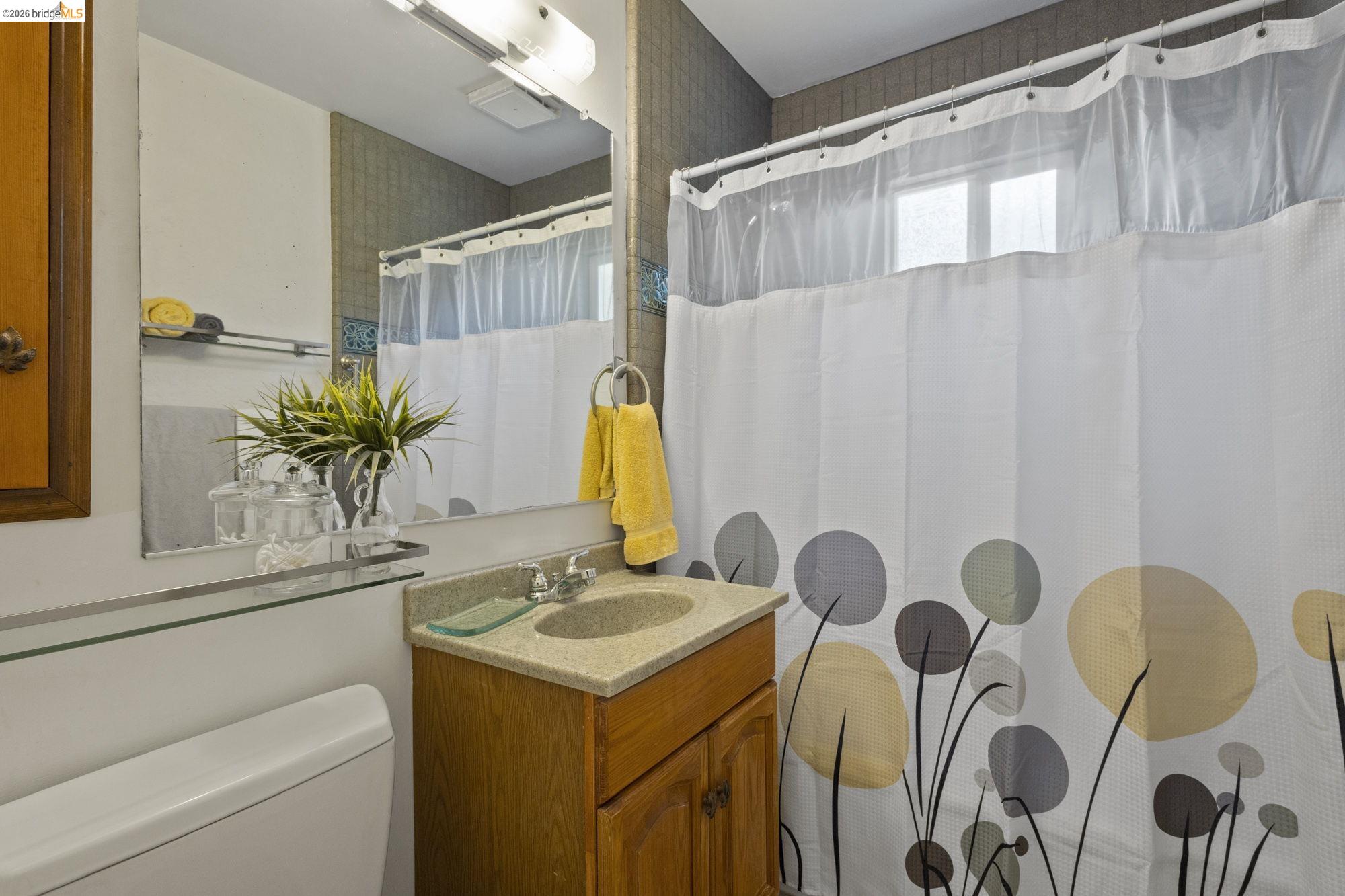 18363 Yosemite Road Tuolumne, CA 95379 - Photo 12 of 34 Bathroom featuring a wood-finish vanity with a light-toned countertop and integrated sink