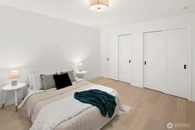 a bedroom with a bed and a night stand