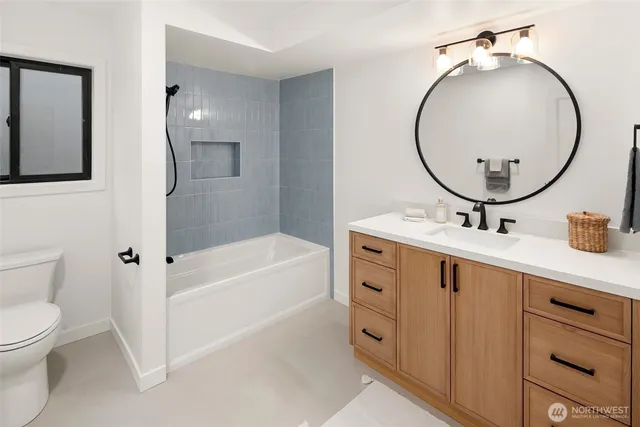 a bathroom with a sink a toilet and a mirror