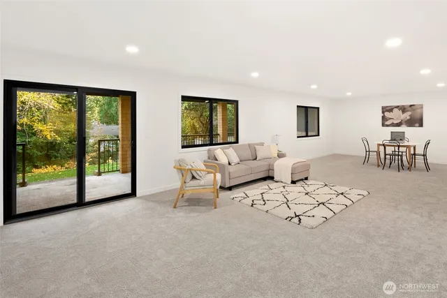 a living room with furniture and large windows