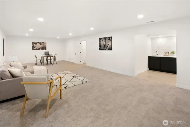 a living room with furniture and a kitchen