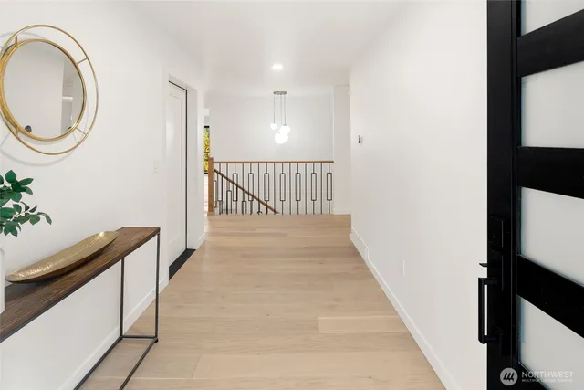 a view of a hallway with wooden floor