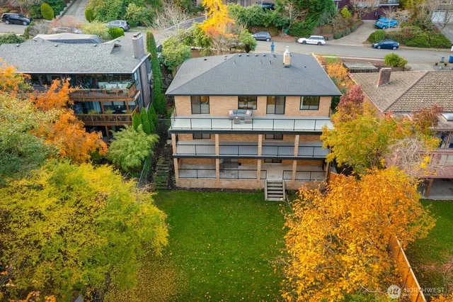an aerial view of a house with a yard basket ball court and outdoor seating