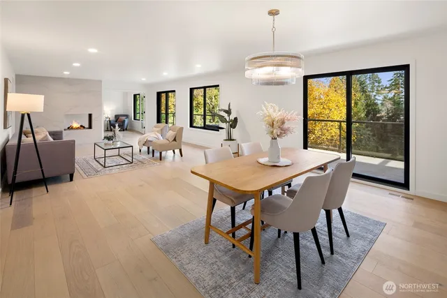 a dining room with furniture a chandelier and wooden floor