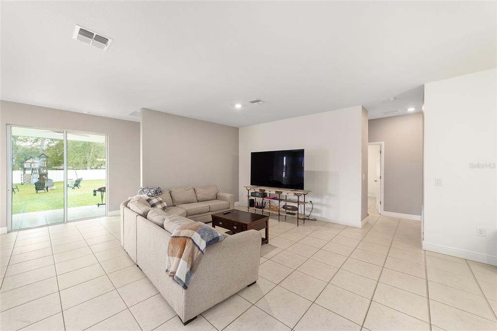 11102 Southwest 58th Avenue Road Ocala, FL 34476 - Photo 12 of 47 a living room with furniture and a flat screen tv