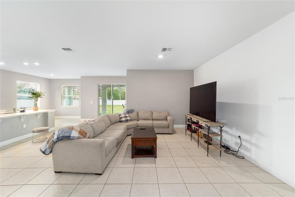 11102 Southwest 58th Avenue Road Ocala, FL 34476 - Photo 13 of 47 a living room with furniture and a flat screen tv