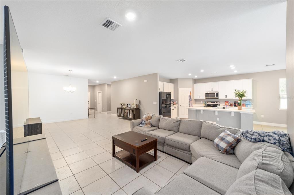 11102 Southwest 58th Avenue Road Ocala, FL 34476 - Photo 15 of 47 a living room with furniture white walls and kitchen view