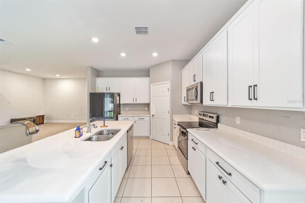 11102 Southwest 58th Avenue Road Ocala, FL 34476 - Photo 18 of 47 a large white kitchen with stainless steel appliances lots of counter top space