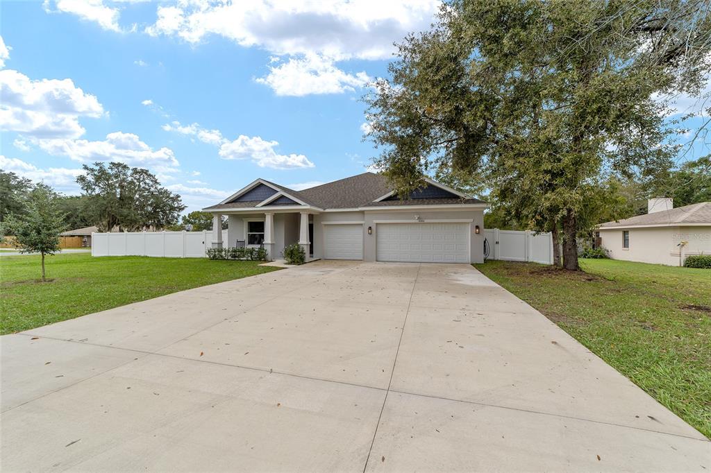 11102 Southwest 58th Avenue Road Ocala, FL 34476 - Photo 3 of 47 a front view of a house with a yard and garage