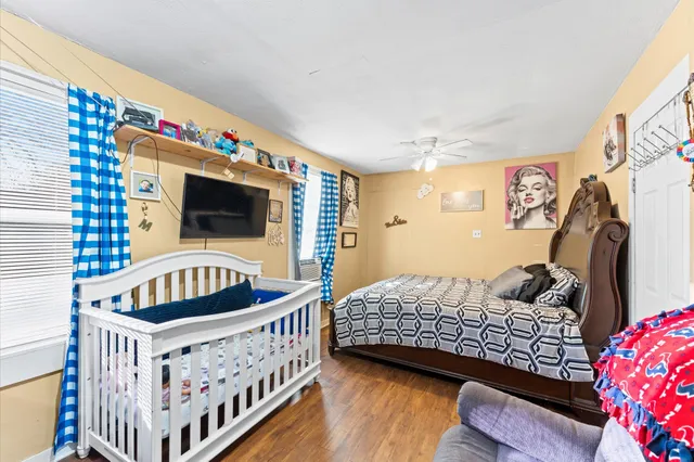 a bedroom with furniture and a flat screen tv