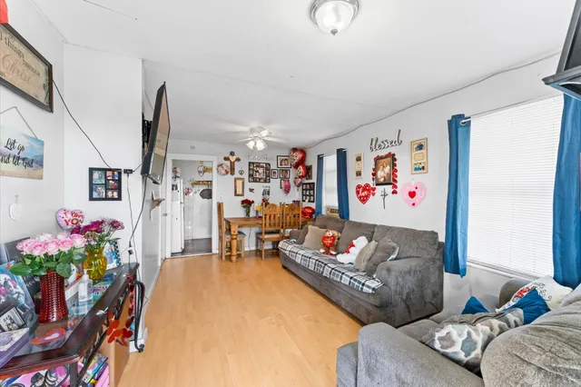 a living room with furniture and flowers