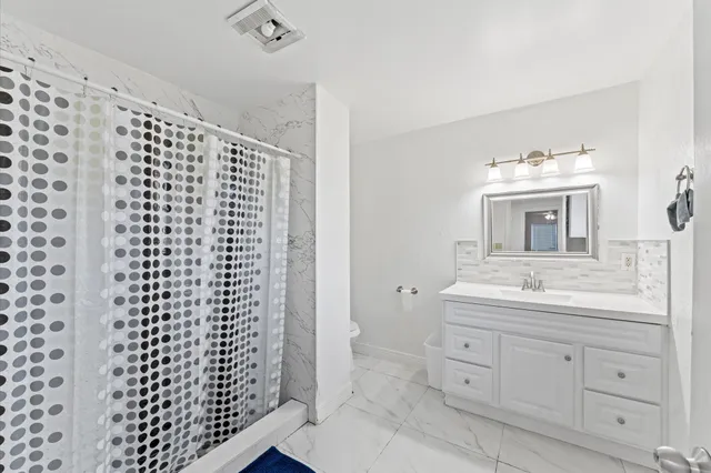 a bathroom with a sink a vanity and a mirror