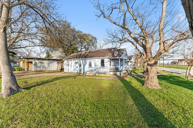 a swimming pool with outdoor seating and yard