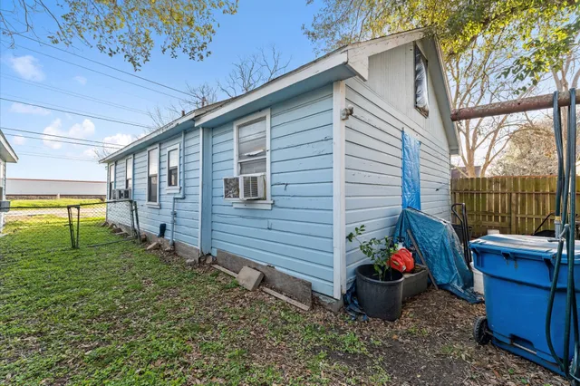 a view of a backyard with chairs and a potted plant