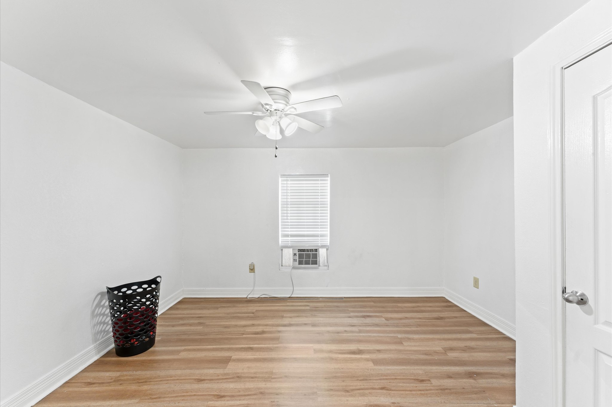 1605 Walnut Avenue Rosenberg, TX 77471 - Photo 6 of 29 a view of an empty room with wooden floor and a window