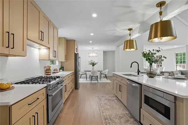 a kitchen with sink stove and cabinets