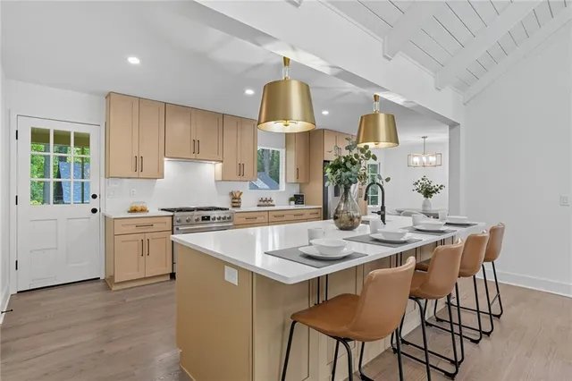 a kitchen with a stove a table and chairs in it
