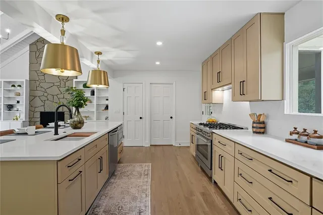 a kitchen with a sink stove and cabinets