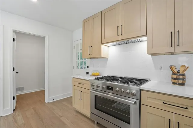 a kitchen with granite countertop white cabinets and white appliances