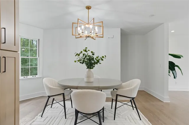 a dining room with furniture potted plants and wooden floor