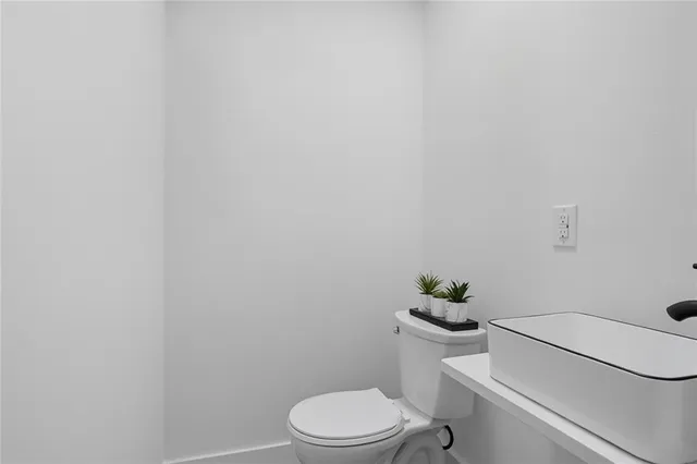 a white toilet sitting next to a shower
