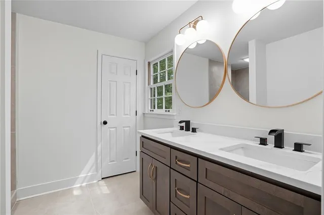 a bathroom with a double vanity sink and a mirror