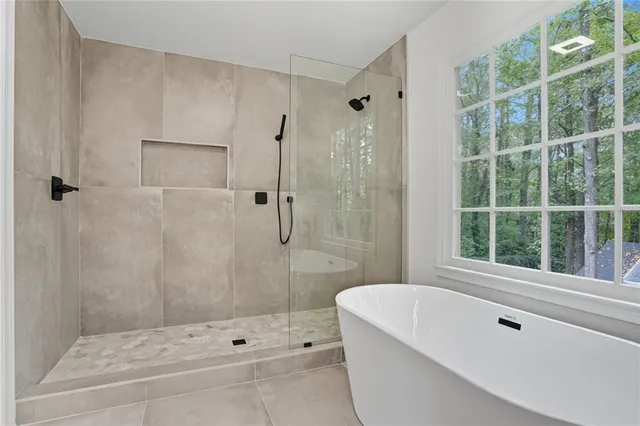 a bathroom with a tub and a shower