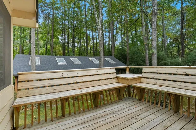 a view of a roof deck with wooden floor and fence