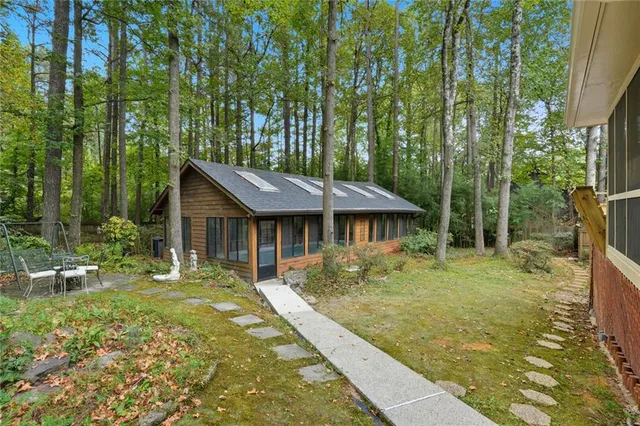 a backyard of a house with table and chairs