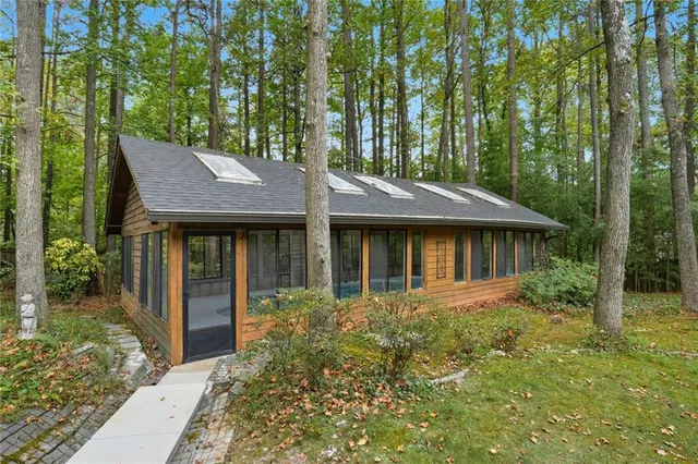 a view of a house with garden and trees