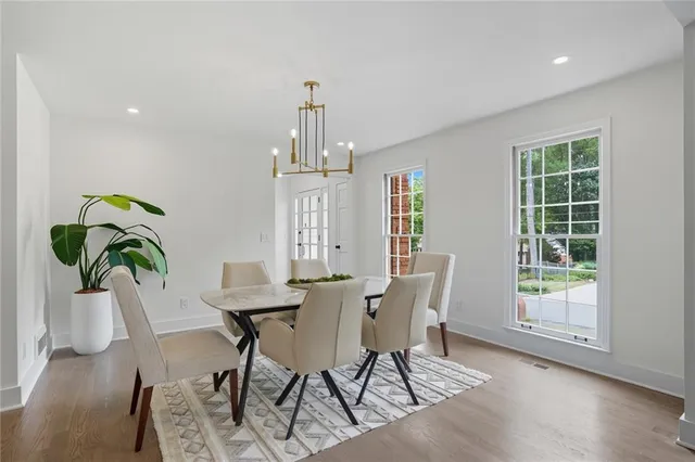 a view of a dining room with furniture window and wooden floor