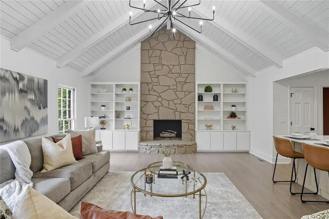 a living room with furniture a rug and a fireplace