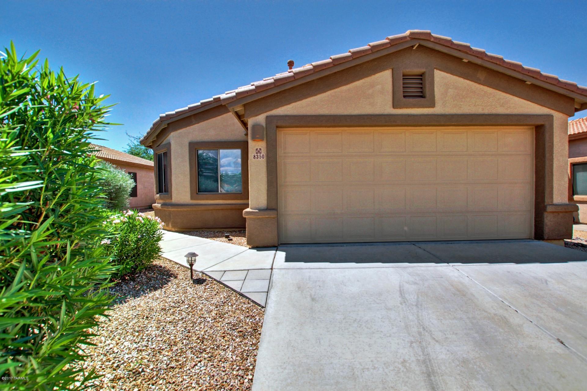 8350 East Bowline Road Tucson, AZ 85710 - Photo 2 of 26 a front view of a house with a yard