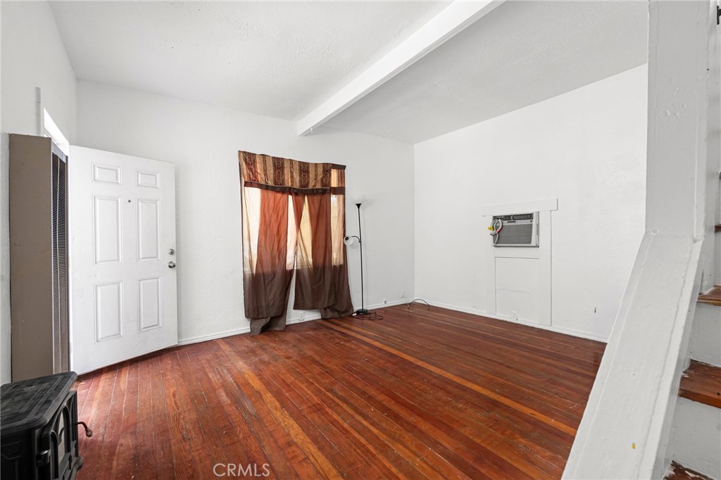 818 6th Street Corning, CA 96021 - Photo 4 of 32 a view of an empty room with wooden floor and a window